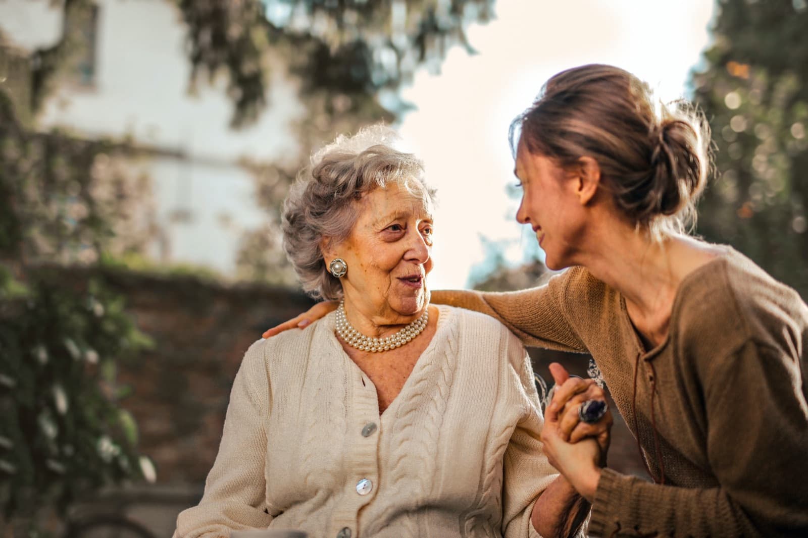 Carer and resident chatting in a garden