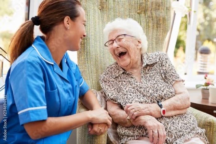 Carer and resident laughing together